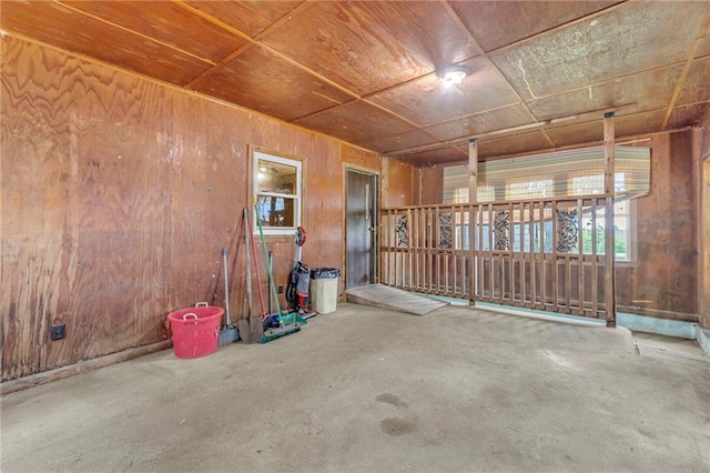 39135 Plum Creek Rd, Osawatomie, KS 66064 - empty room featuring wooden walls and concrete flooring