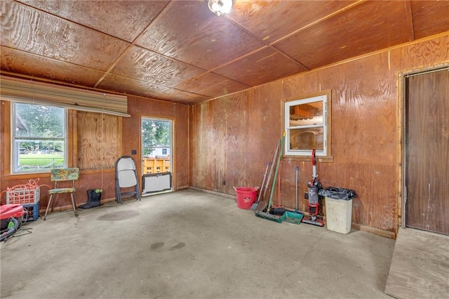 39135 Plum Creek Rd, Osawatomie, KS 66064 - miscellaneous room with unfinished concrete flooring and wooden walls