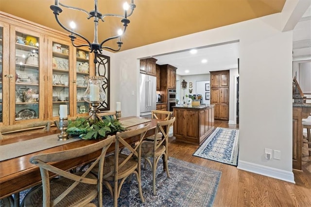 4325 W 112th St, Leawood, KS 66211 - dining room featuring a chandelier, wood finished floors, and recessed lighting