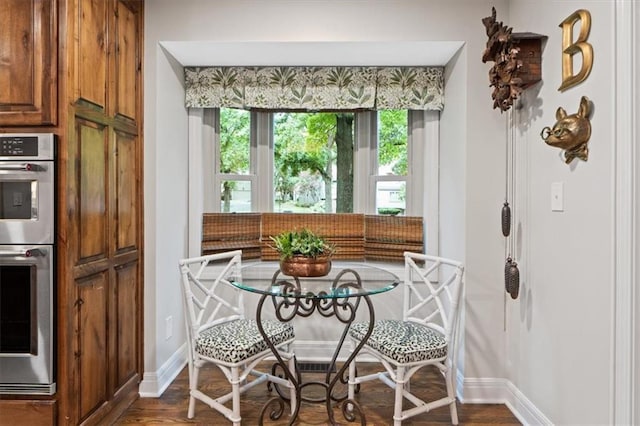 4325 W 112th St, Leawood, KS 66211 - dining space featuring baseboards and dark wood finished floors