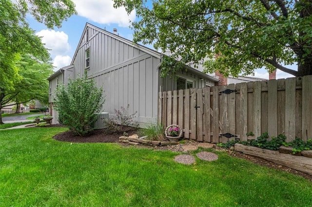 4325 W 112th St, Leawood, KS 66211 - view of side of home with board and batten siding and a central air condition unit