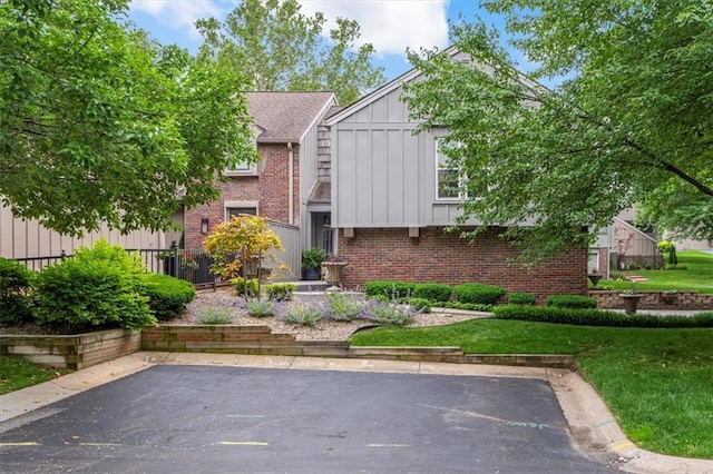 4325 W 112th St, Leawood, KS 66211 - view of front of home featuring board and batten siding and brick siding