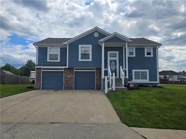 657 SW Tisha Ln, Grain Valley, MO 64029 - bi-level home featuring concrete driveway and an attached garage