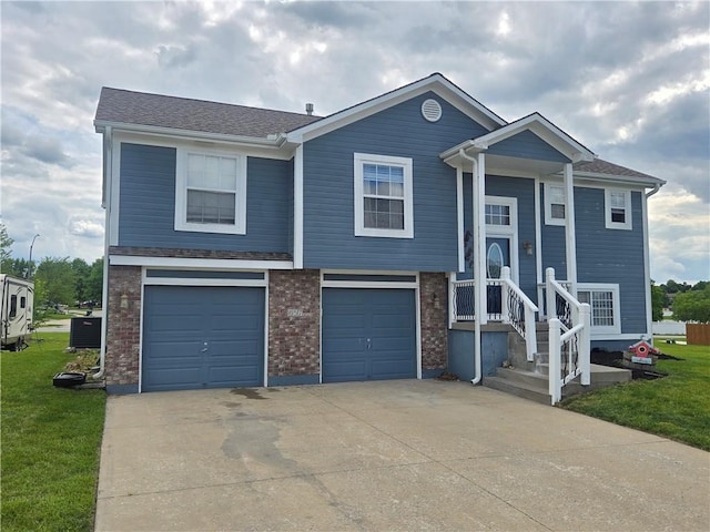 657 SW Tisha Ln, Grain Valley, MO 64029 - view of front facade featuring driveway, central AC unit, a front yard, a garage, and brick siding