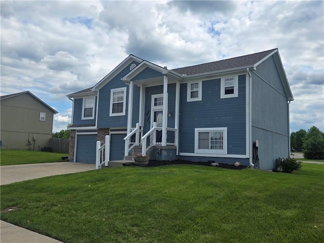 657 SW Tisha Ln, Grain Valley, MO 64029 - split foyer home featuring concrete driveway, a garage, and a front yard