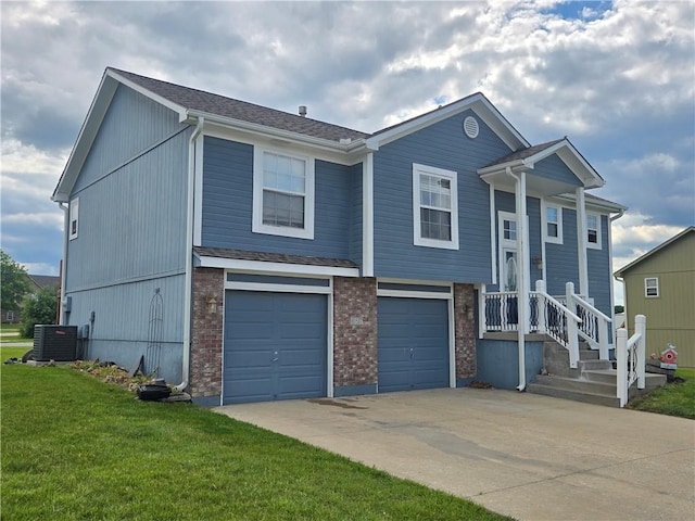 657 SW Tisha Ln, Grain Valley, MO 64029 - view of front of house with driveway, a front lawn, central air condition unit, an attached garage, and brick siding