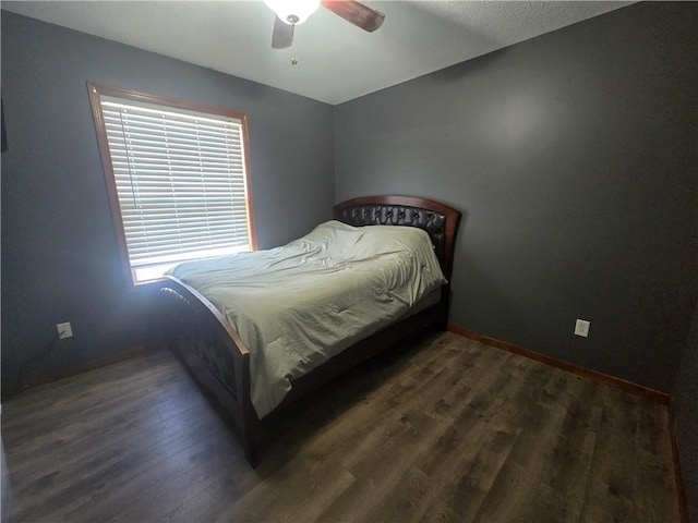 657 SW Tisha Ln, Grain Valley, MO 64029 - bedroom featuring dark wood-style flooring, baseboards, and a ceiling fan