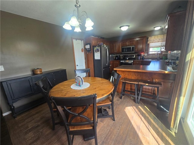 657 SW Tisha Ln, Grain Valley, MO 64029 - dining area with a chandelier and wood finished floors