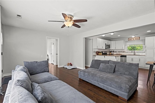 1304 6th Ave, Leavenworth, KS 66048 - living room with a ceiling fan and dark wood-style flooring