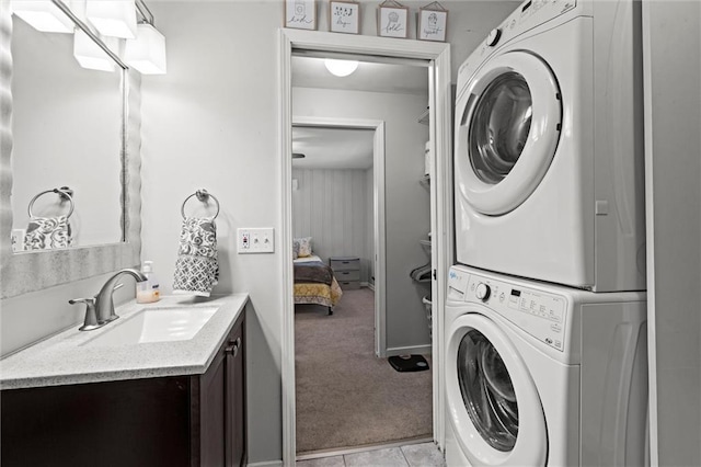 1304 6th Ave, Leavenworth, KS 66048 - washroom with stacked washer / drying machine, light colored carpet, and light tile patterned flooring