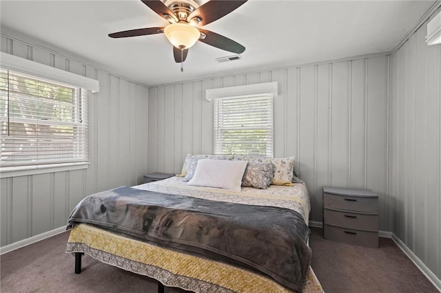 1304 6th Ave, Leavenworth, KS 66048 - carpeted bedroom featuring multiple windows, a ceiling fan, and a decorative wall