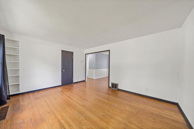 2504 NE 60th St, Gladstone, MO 64118 - unfurnished room with wood finished floors, built in features, and baseboards