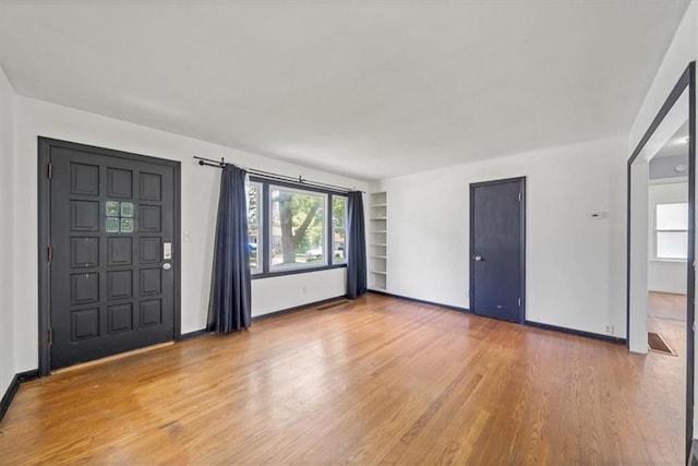 2504 NE 60th St, Gladstone, MO 64118 - entryway with light wood-type flooring, baseboards, and plenty of natural light