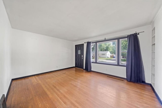 2504 NE 60th St, Gladstone, MO 64118 - unfurnished room with light wood finished floors, built in features, and baseboards