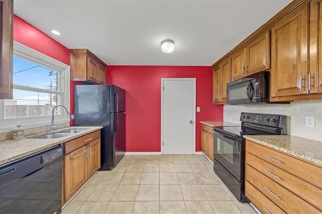 2504 NE 60th St, Gladstone, MO 64118 - kitchen with black appliances, a sink, brown cabinets, light stone countertops, and baseboards