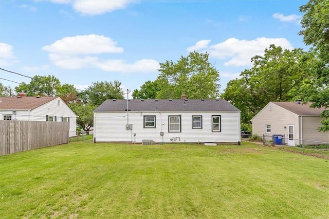 2504 NE 60th St, Gladstone, MO 64118 - back of house with central air condition unit and a chimney