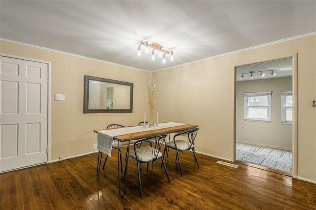 808 NE 62nd St, Gladstone, MO 64118 - dining space with track lighting, wood finished floors, ornamental molding, and baseboards