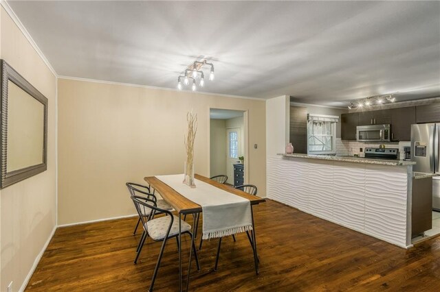 808 NE 62nd St, Gladstone, MO 64118 - dining room featuring crown molding and dark wood-type flooring