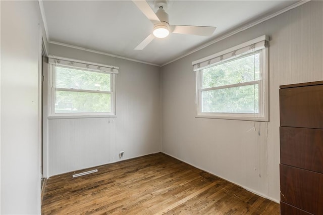 808 NE 62nd St, Gladstone, MO 64118 - unfurnished room featuring ornamental molding, healthy amount of natural light, ceiling fan, and wood finished floors