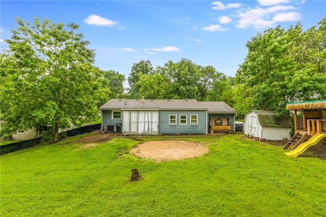 808 NE 62nd St, Gladstone, MO 64118 - rear view of property featuring a playground and view of scattered trees