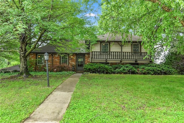 1131 Wildwood St, Leavenworth, KS 66048 - view of front of property featuring a front lawn, a shingled roof, and brick siding