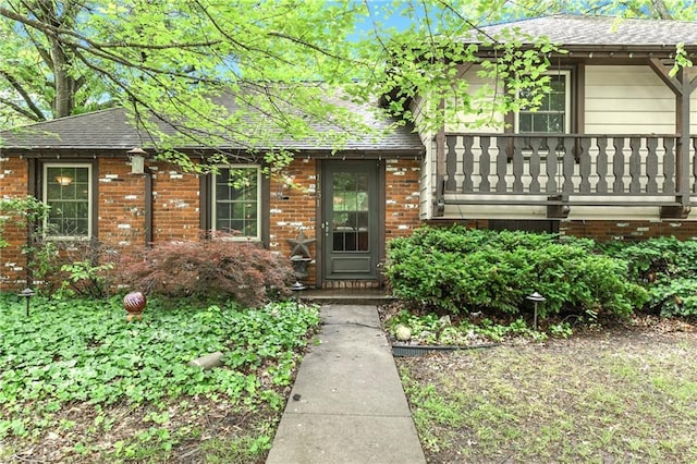 1131 Wildwood St, Leavenworth, KS 66048 - view of front facade featuring a shingled roof and brick siding