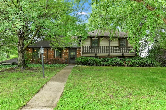 1131 Wildwood St, Leavenworth, KS 66048 - tri-level home with a front lawn, a shingled roof, and brick siding