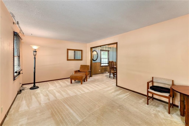 1131 Wildwood St, Leavenworth, KS 66048 - sitting room featuring light colored carpet, baseboards, and a textured ceiling
