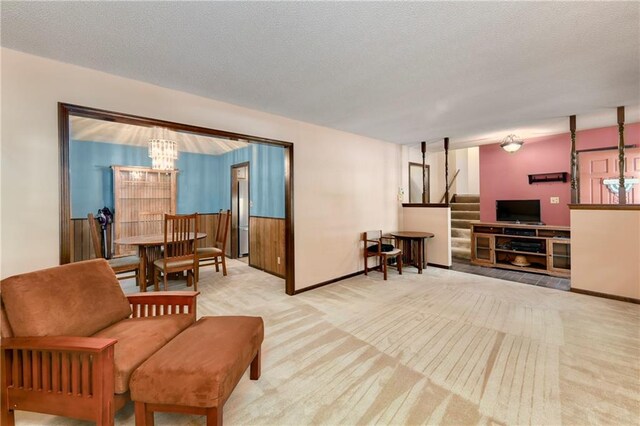 1131 Wildwood St, Leavenworth, KS 66048 - living room with a chandelier, stairway, carpet flooring, and a textured ceiling