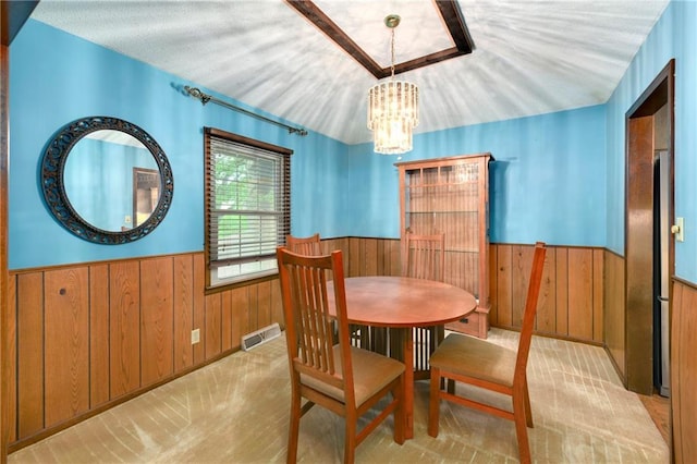 1131 Wildwood St, Leavenworth, KS 66048 - dining space with wainscoting, a chandelier, and wooden walls