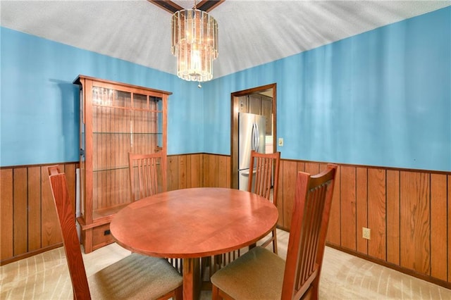 1131 Wildwood St, Leavenworth, KS 66048 - dining room with wooden walls, a wainscoted wall, a chandelier, and carpet flooring