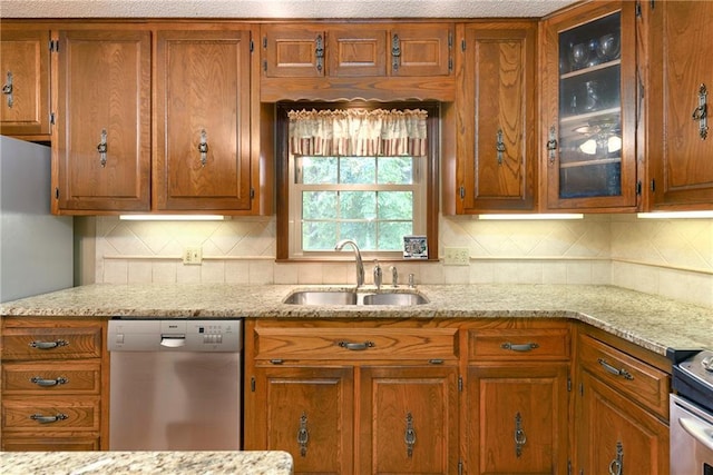 1131 Wildwood St, Leavenworth, KS 66048 - kitchen with stainless steel appliances, a sink, and brown cabinetry