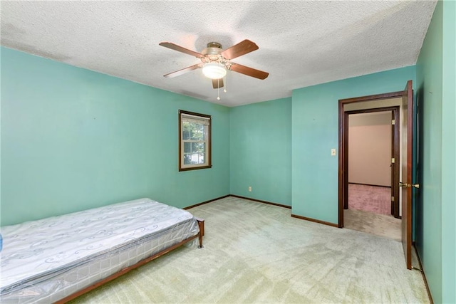 1131 Wildwood St, Leavenworth, KS 66048 - carpeted bedroom featuring a textured ceiling, baseboards, and ceiling fan