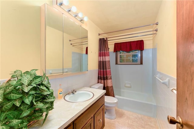 1131 Wildwood St, Leavenworth, KS 66048 - bathroom with tile walls, toilet, vanity, shower / bath combination with curtain, and a wainscoted wall