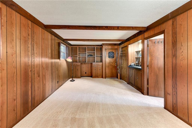 1131 Wildwood St, Leavenworth, KS 66048 - carpeted spare room with wooden walls and beam ceiling