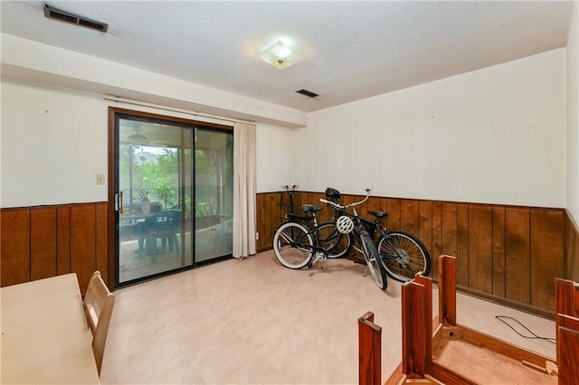 1131 Wildwood St, Leavenworth, KS 66048 - playroom with a wainscoted wall, wooden walls, and a textured ceiling