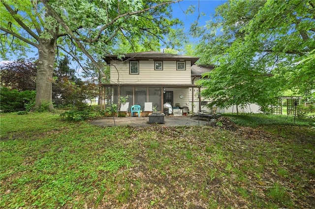 1131 Wildwood St, Leavenworth, KS 66048 - rear view of house with a sunroom and a patio area