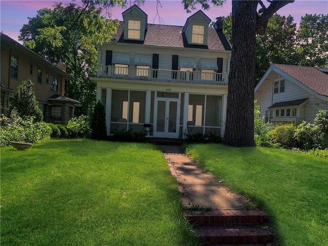4935 Wyoming St, Kansas City, MO 64112 - view of front of home with a balcony, french doors, a sunroom, and a front lawn