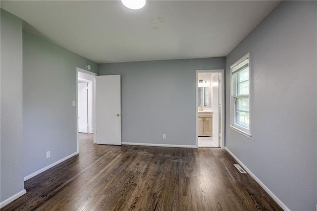 9203 James A Reed Rd, Kansas City, MO 64138 - unfurnished room featuring wood finished floors and baseboards
