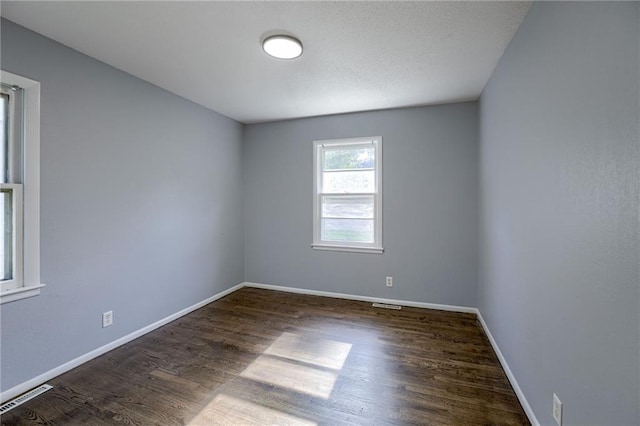 9203 James A Reed Rd, Kansas City, MO 64138 - empty room with wood finished floors and baseboards