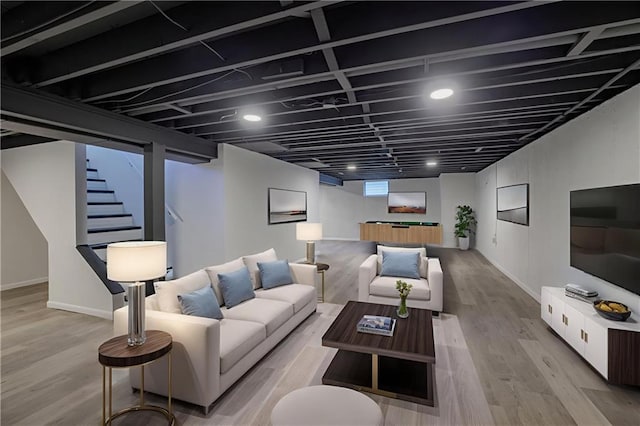 9203 James A Reed Rd, Kansas City, MO 64138 - living room featuring stairway, wood finished floors, and baseboards