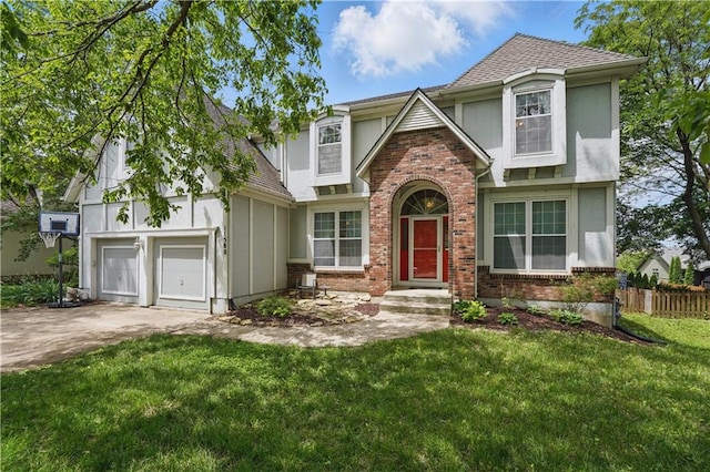 11580 S Skyview Ln, Olathe, KS 66061 - tudor-style house with stucco siding, concrete driveway, brick siding, a garage, and a shingled roof