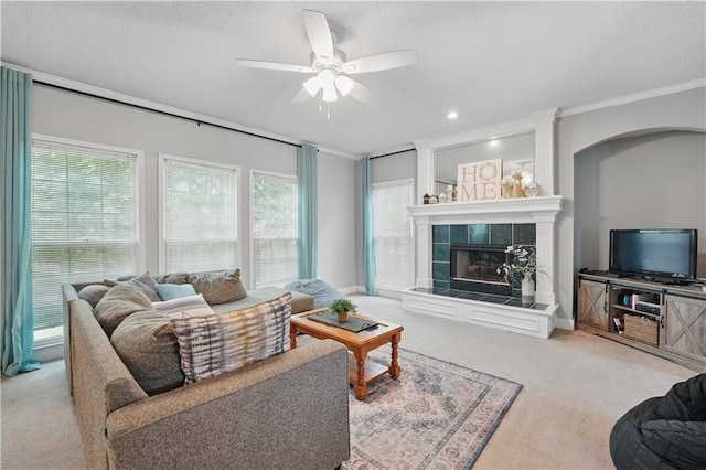 11580 S Skyview Ln, Olathe, KS 66061 - living room featuring carpet, a ceiling fan, crown molding, a fireplace, and a textured ceiling