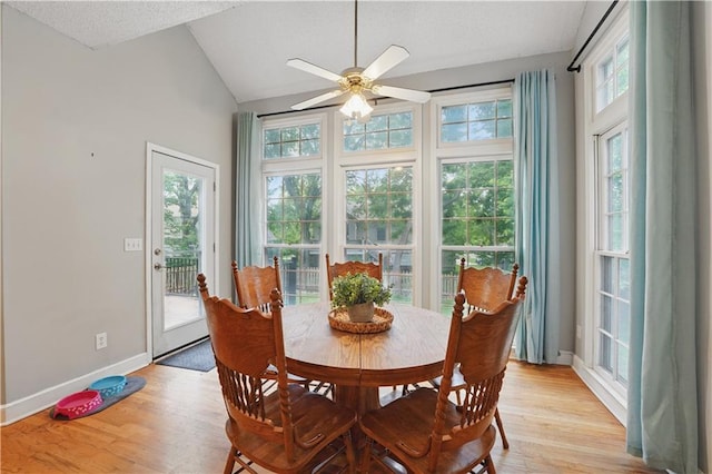 11580 S Skyview Ln, Olathe, KS 66061 - dining space featuring plenty of natural light, light wood finished floors, a ceiling fan, lofted ceiling, and baseboards