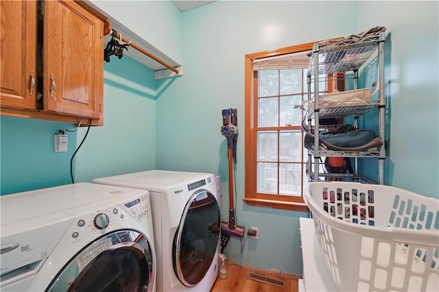 11580 S Skyview Ln, Olathe, KS 66061 - laundry room featuring cabinet space, washer and dryer, and wood finished floors