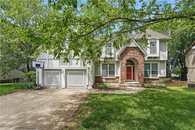 11580 S Skyview Ln, Olathe, KS 66061 - tudor-style house featuring driveway, brick siding, a garage, and stucco siding