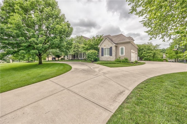 14606 Granada Rd, Leawood, KS 66224 - view of front of home featuring stone siding, a front lawn, stucco siding, and curved driveway