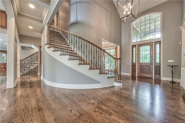 14606 Granada Rd, Leawood, KS 66224 - foyer entrance featuring stairs, wood finished floors, a high ceiling, baseboards, and plenty of natural light