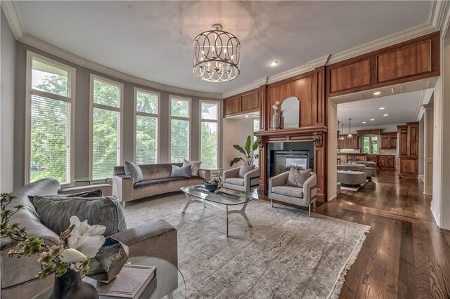 14606 Granada Rd, Leawood, KS 66224 - living area with ornamental molding, a large fireplace, dark wood finished floors, a chandelier, and recessed lighting