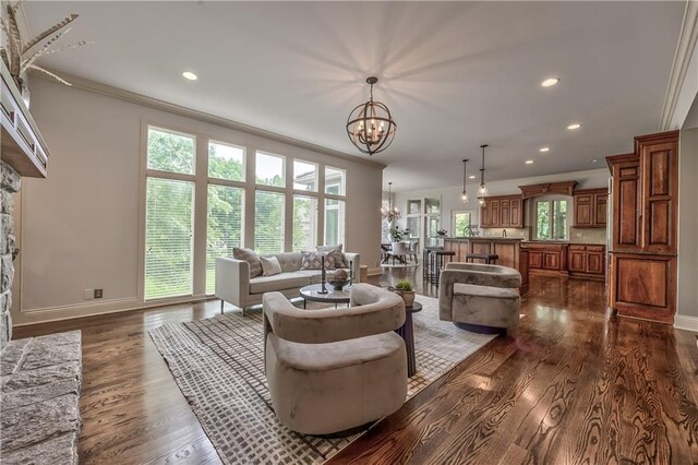 14606 Granada Rd, Leawood, KS 66224 - living room featuring a chandelier, baseboards, dark wood finished floors, recessed lighting, and crown molding